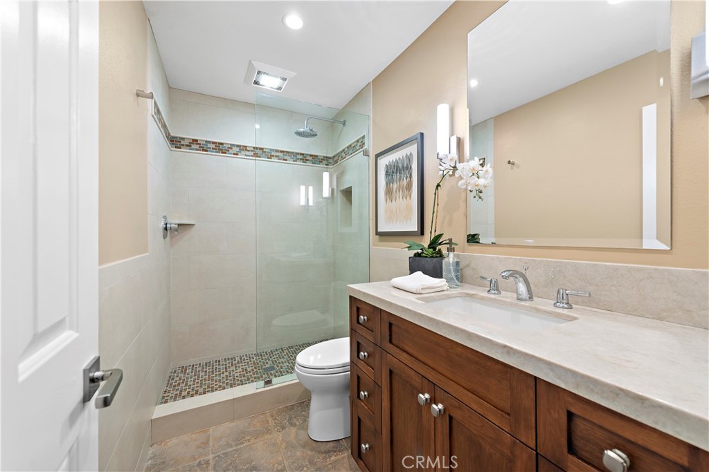 5 High Bluff Laguna Niguel, CA 92677 - Photo 38 of 64 a bathroom with a sink a toilet a mirror and shower