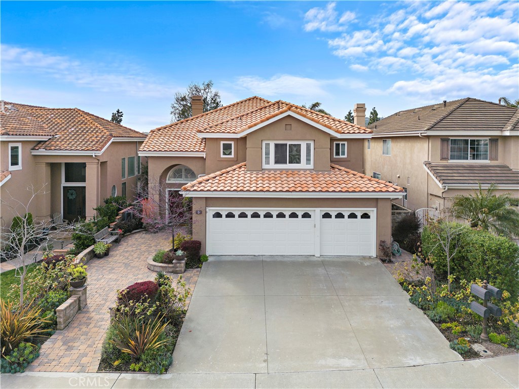 5 High Bluff Laguna Niguel, CA 92677 - Photo 49 of 64 a view of a white house with a flower garden in front of it