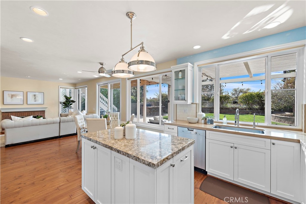 5 High Bluff Laguna Niguel, CA 92677 - Photo 5 of 64 a open kitchen with granite countertop a sink and dishwasher with wooden floor
