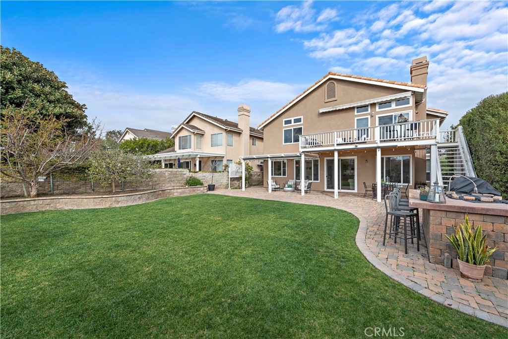 5 High Bluff Laguna Niguel, CA 92677 - Photo 61 of 64 a front view of a house with a yard table and chairs