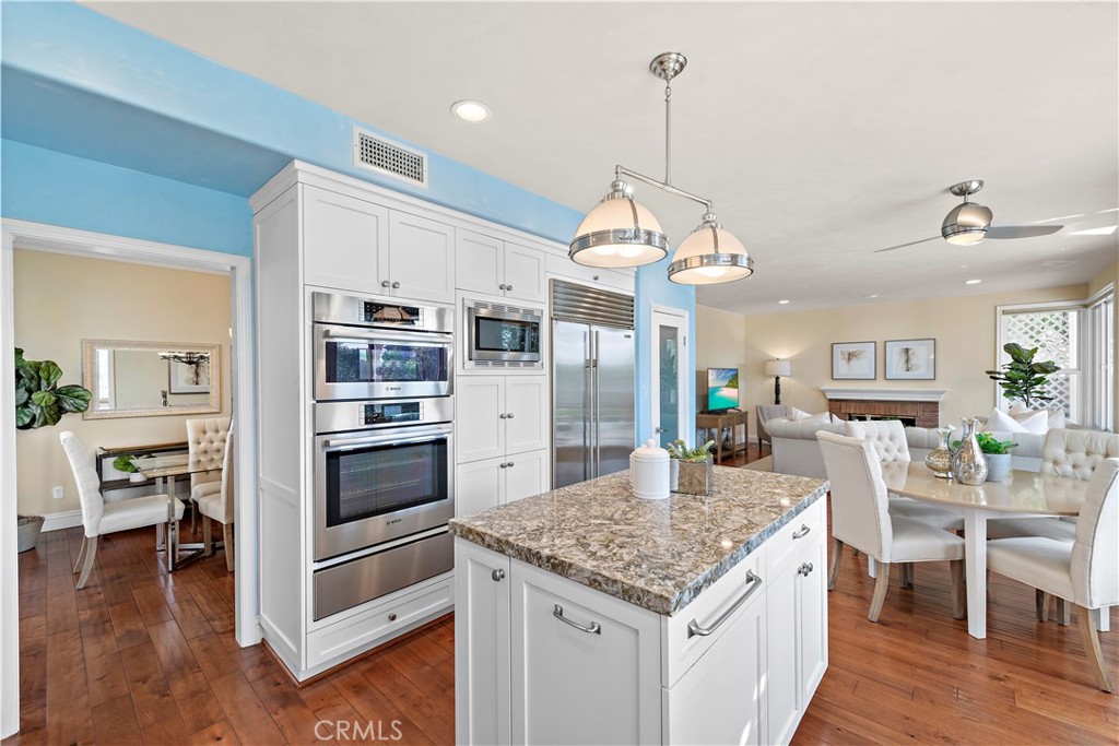 5 High Bluff Laguna Niguel, CA 92677 - Photo 7 of 64 a kitchen with stainless steel appliances granite countertop a stove oven and a dining table