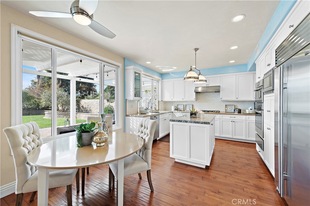 5 High Bluff Laguna Niguel, CA 92677 - Photo 10 of 64 a kitchen with kitchen island wooden floor dining table and stainless steel appliances