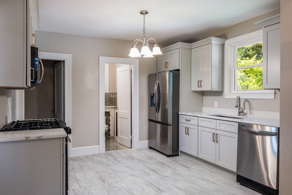 122 Bellevue Avenue Springfield, MA 01108 - Photo 14 of 32 a kitchen with stainless steel appliances granite countertop a refrigerator and a stove top oven