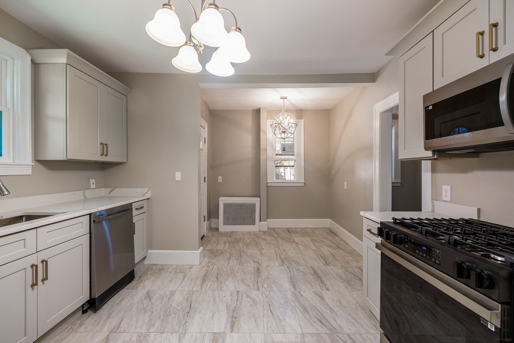 122 Bellevue Avenue Springfield, MA 01108 - Photo 15 of 32 a kitchen with stainless steel appliances a stove a sink and a microwave