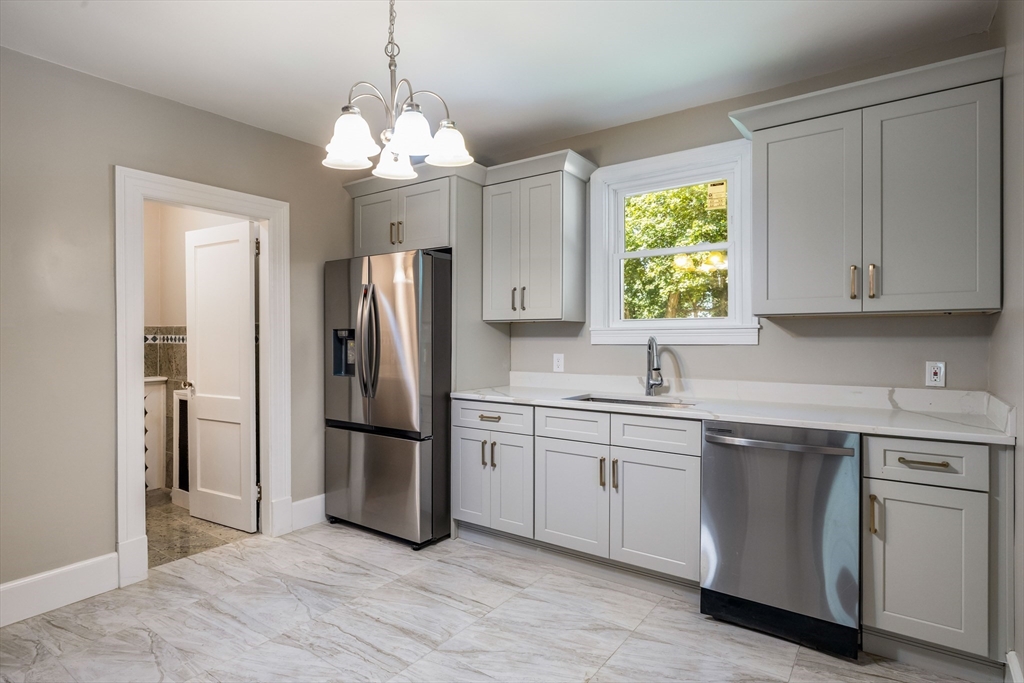 122 Bellevue Avenue Springfield, MA 01108 - Photo 17 of 32 a kitchen with a refrigerator and a sink