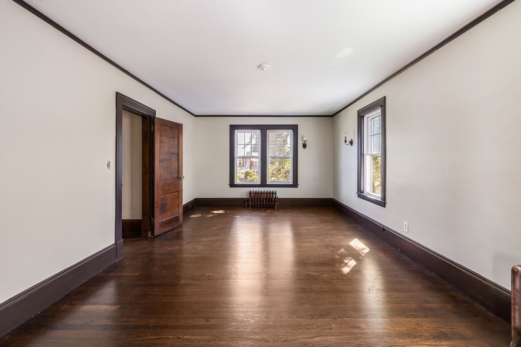 122 Bellevue Avenue Springfield, MA 01108 - Photo 20 of 32 an empty room with wooden floor and windows