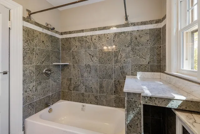 a view of hallway with wooden floor and chandelier