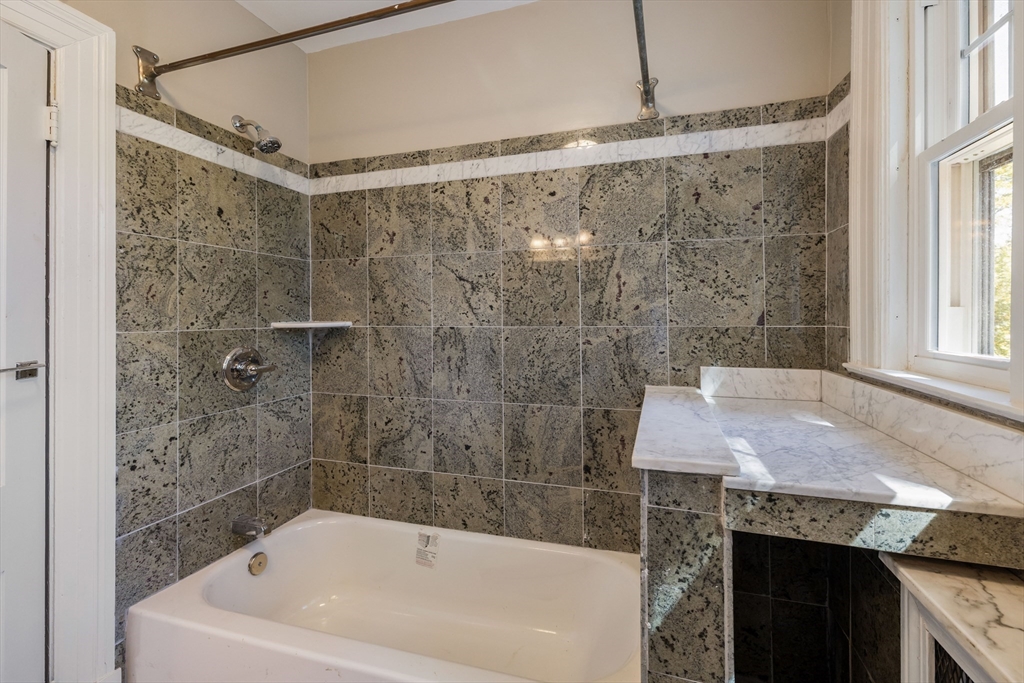 122 Bellevue Avenue Springfield, MA 01108 - Photo 22 of 32 a bath tub sitting next to a bathroom