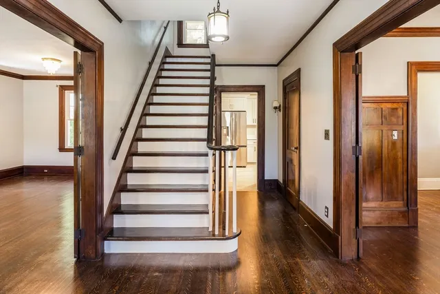a view of entryway with wooden floor and stair