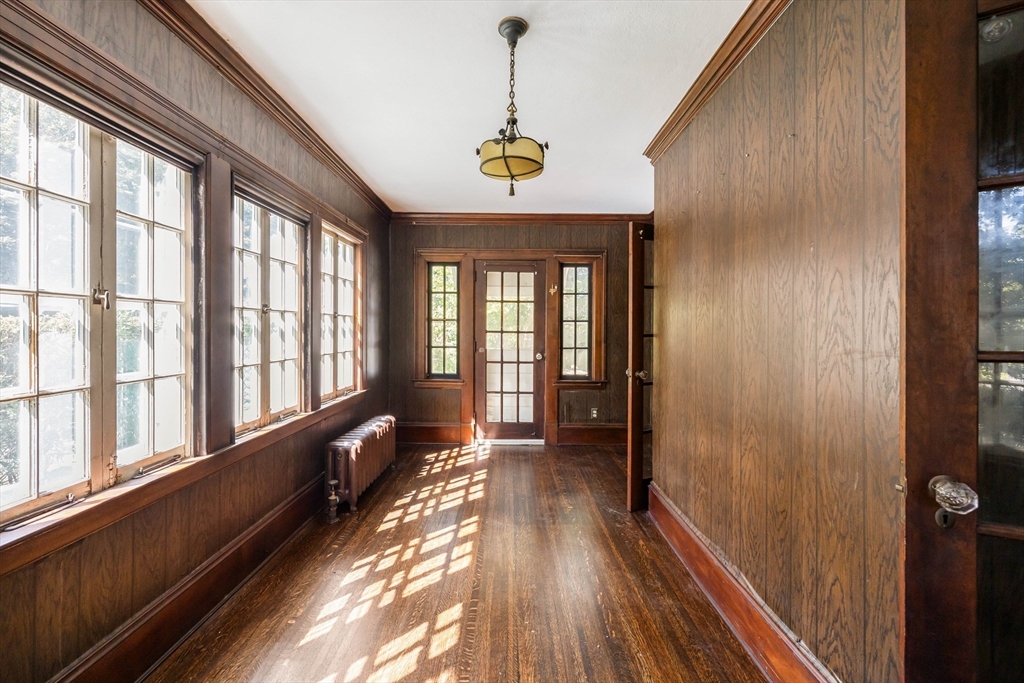 122 Bellevue Avenue Springfield, MA 01108 - Photo 9 of 32 a hallway with wooden floor chandelier and entryway