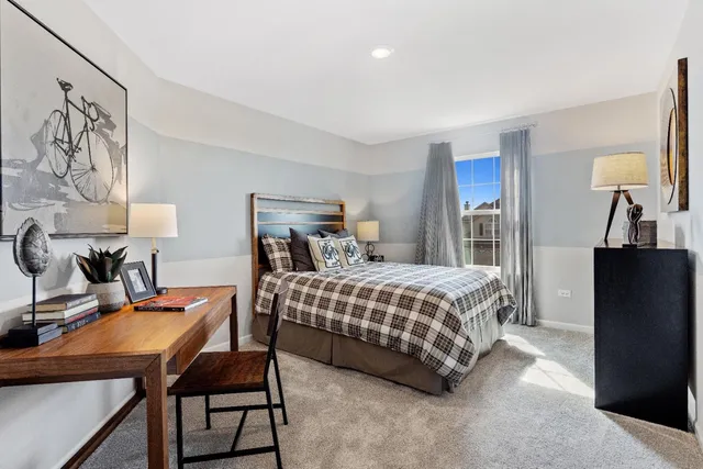 a bedroom with a bed and a table in it