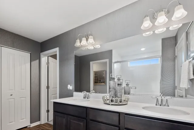 a bathroom with a double vanity sink and a mirror