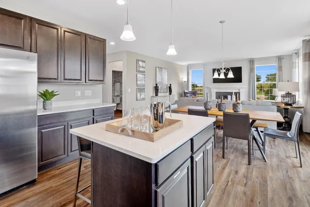 a kitchen with a sink cabinets and wooden floor