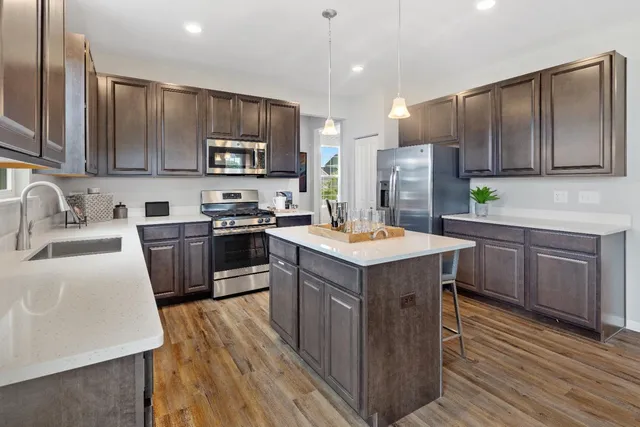 a kitchen with a sink refrigerator and a microwave