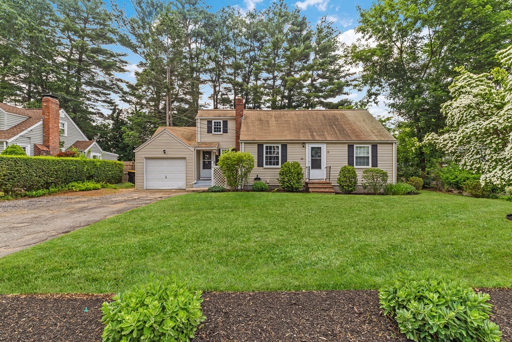 34 Londonderry Road Framingham, MA 01701 - Photo 1 of 33 a front view of a house with a garden and trees