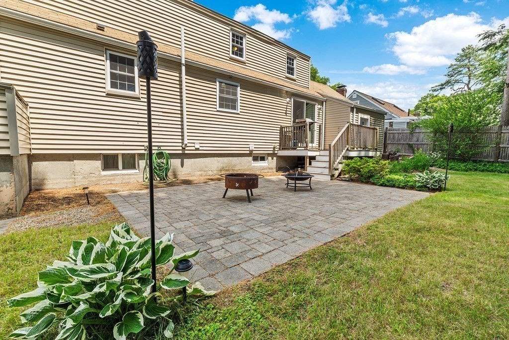 34 Londonderry Road Framingham, MA 01701 - Photo 30 of 33 a backyard of a house with table and chairs