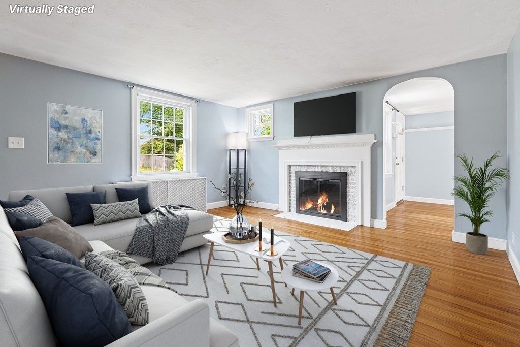 34 Londonderry Road Framingham, MA 01701 - Photo 9 of 33 a living room with furniture a flat screen tv and a fireplace