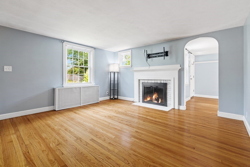 34 Londonderry Road Framingham, MA 01701 - Photo 10 of 33 a view of an empty room with wooden floor fireplace and a window
