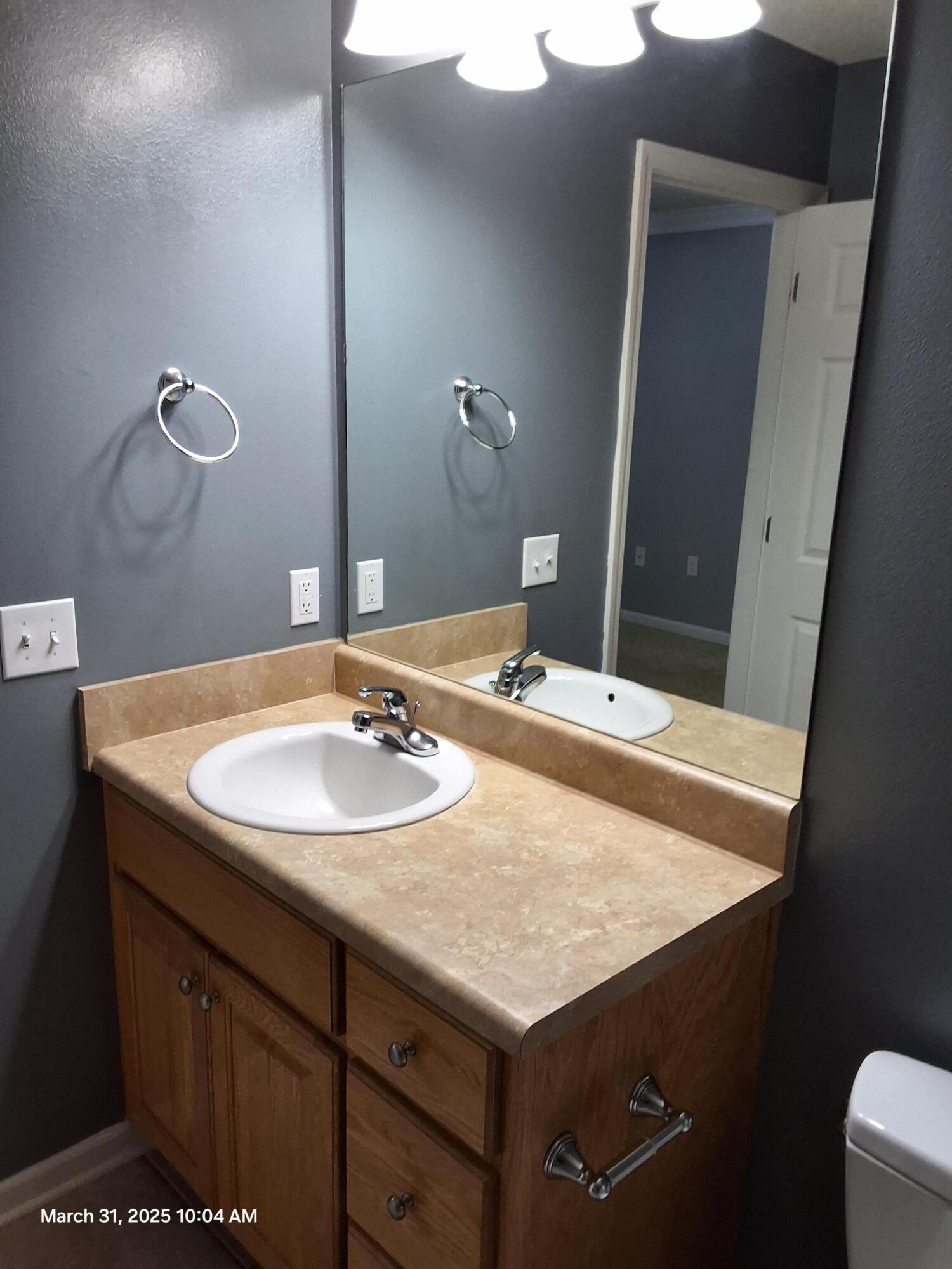 701 Georgia Street Crestview, FL 32536 - Photo 18 of 26 a bathroom with a sink and a mirror