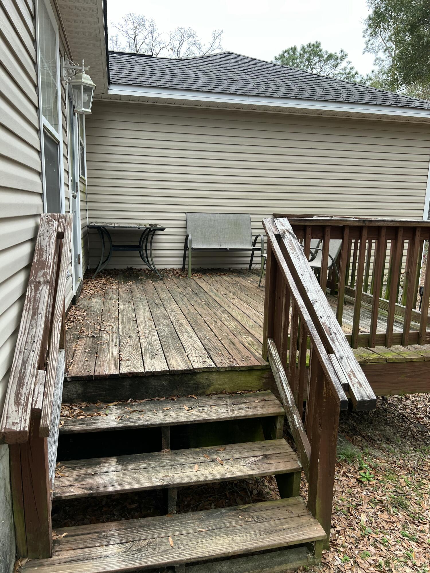701 Georgia Street Crestview, FL 32536 - Photo 3 of 26 a view of a balcony with wooden floor and fence