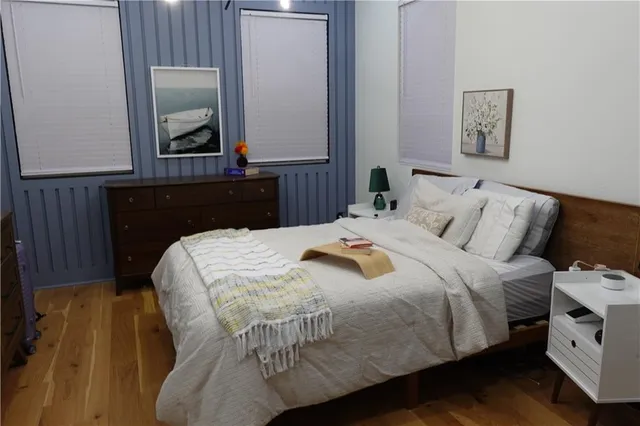 a bedroom with a bed and a mirror
