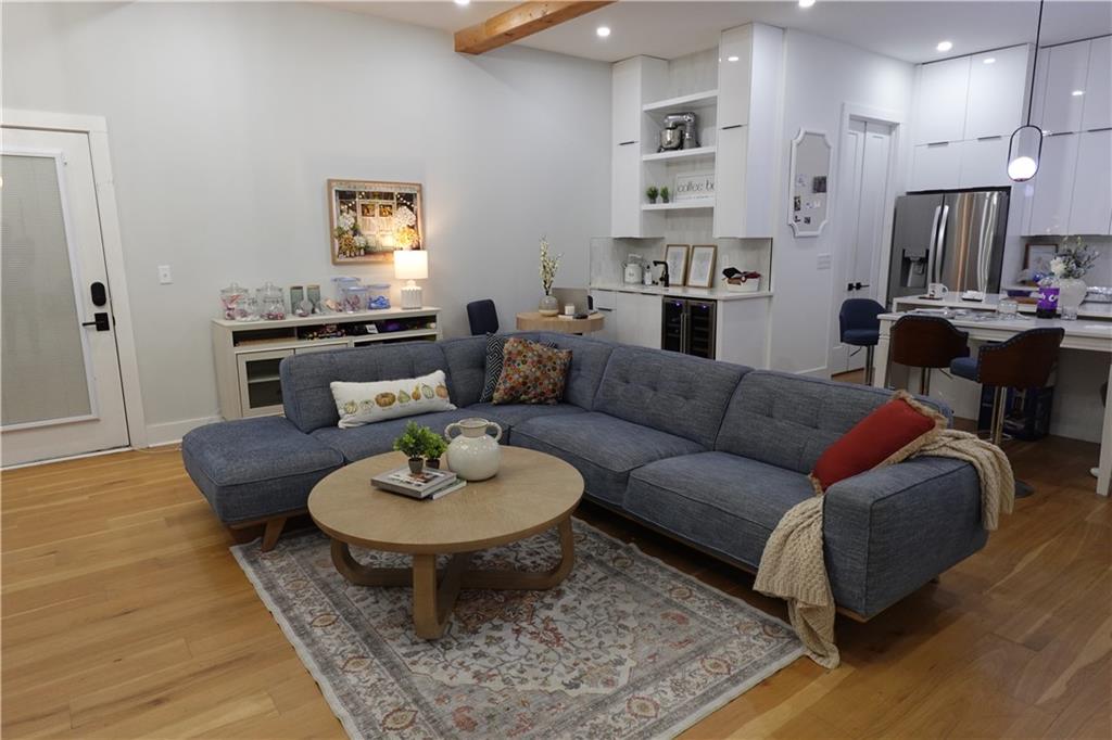 3473 Harding Avenue Atlanta, GA 30354 - Photo 22 of 25 a living room with furniture and a dining table with wooden floor
