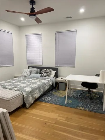 a bedroom with a bed and a desk