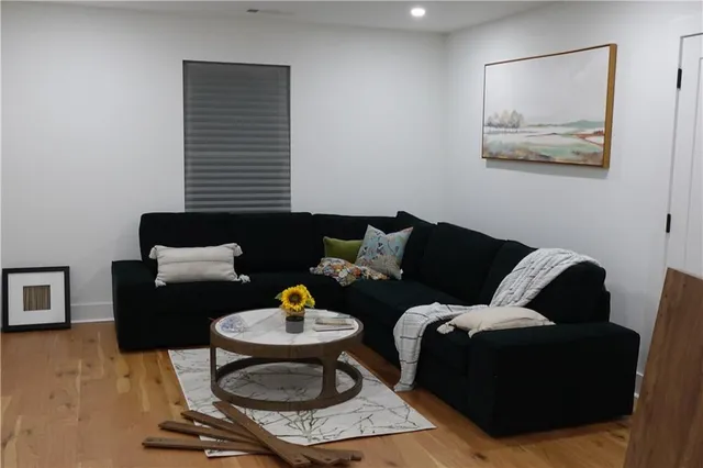 a living room with furniture and a wooden floor