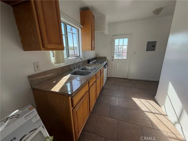 a kitchen that has a sink and a stove