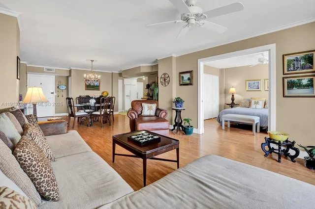a living room with furniture a rug and a chandelier