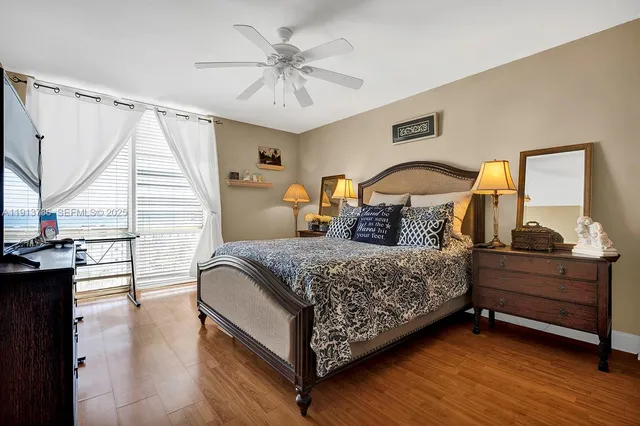 a bedroom with a bed a dresser and window