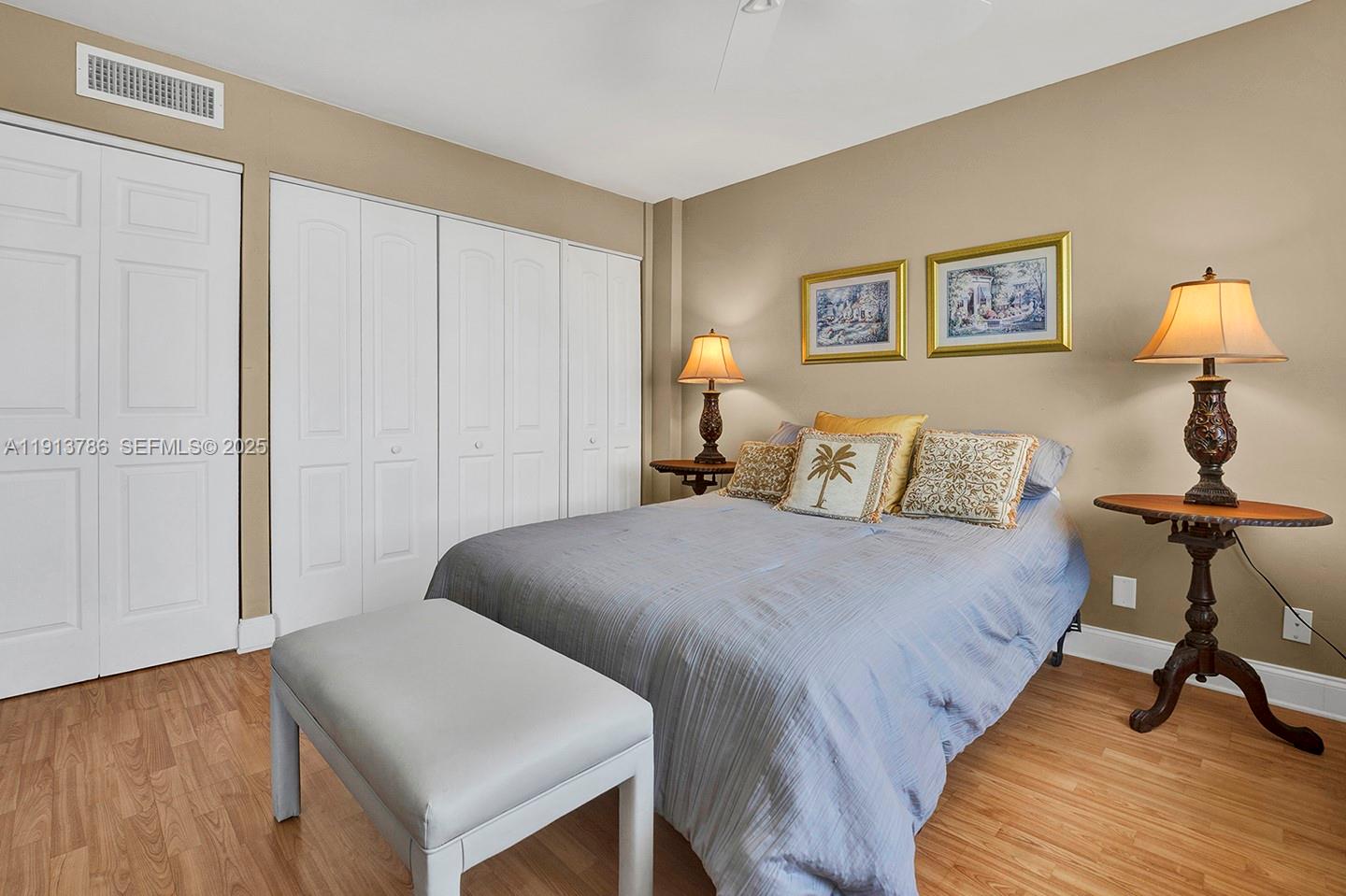 1500 South Ocean Drive, Unit 9J Hollywood, FL 33019 - Photo 13 of 32 a bedroom with a bed and a lamp on table