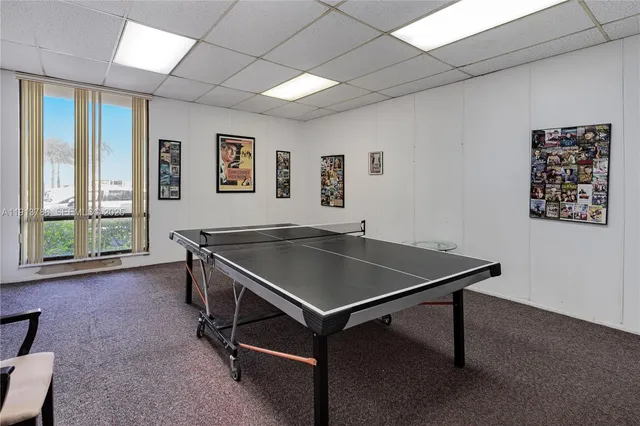a room with pool table and windows
