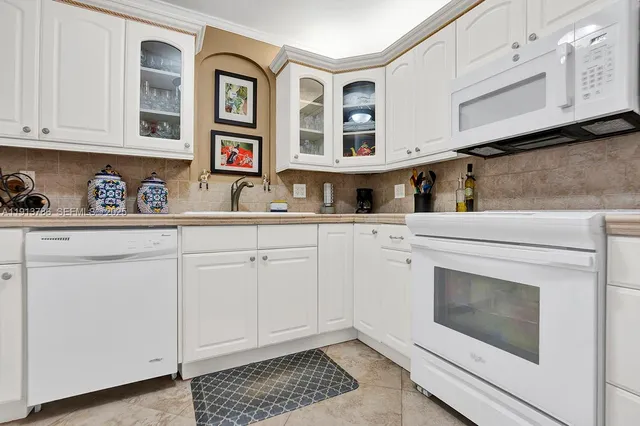 a kitchen with stainless steel appliances granite countertop a sink and cabinets