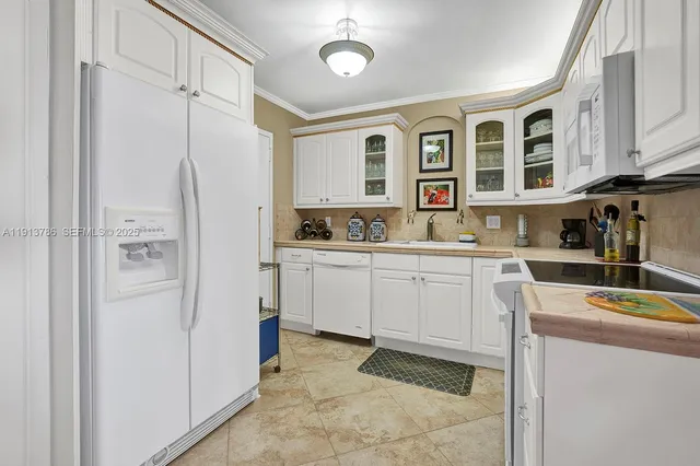 a kitchen with cabinets appliances and a window