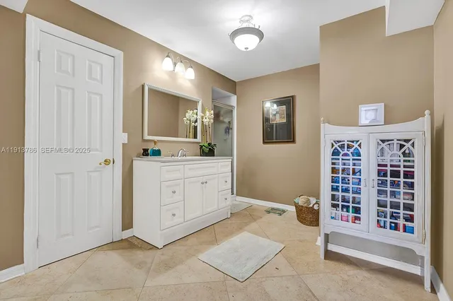 a view of kitchen with granite countertop cabinets and sink