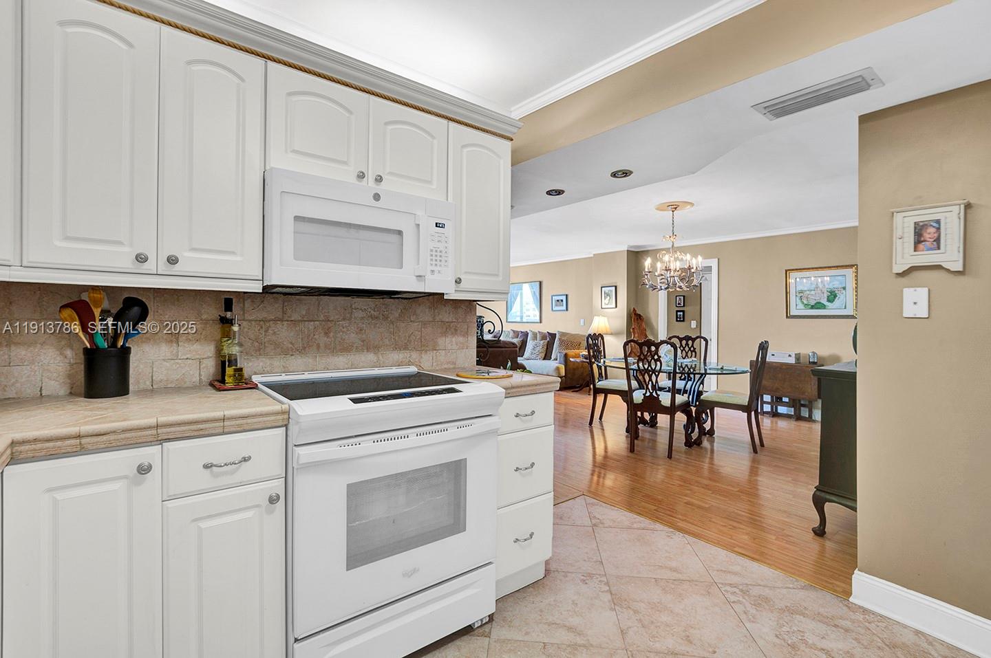 1500 South Ocean Drive, Unit 9J Hollywood, FL 33019 - Photo 9 of 32 a kitchen with white cabinets and appliances