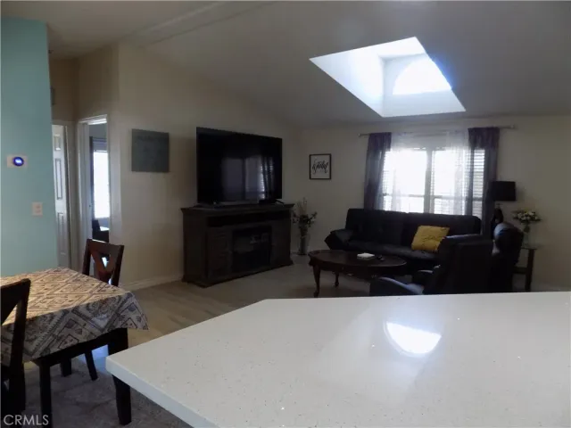 a view of a dining room with furniture and chandelier