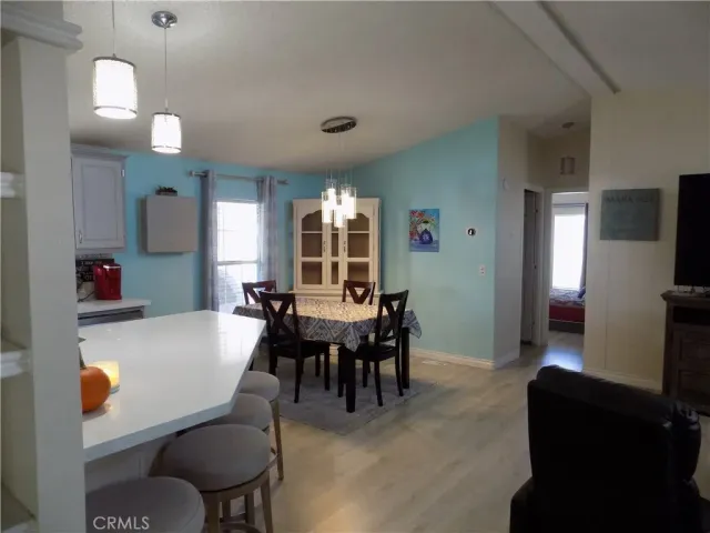 a kitchen with a sink cabinets and dining table