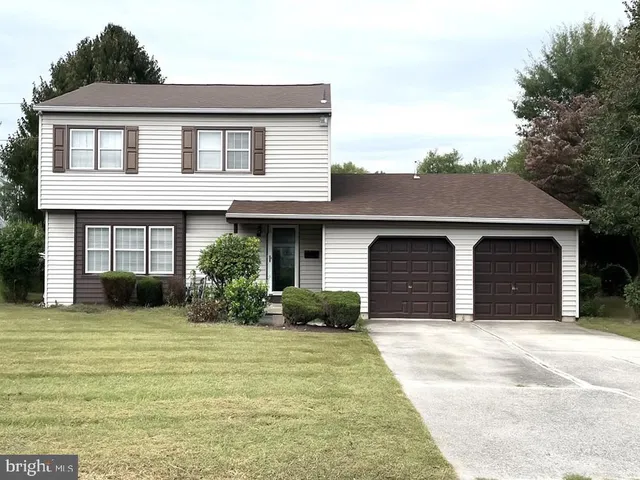 a front view of a house with yard and garage