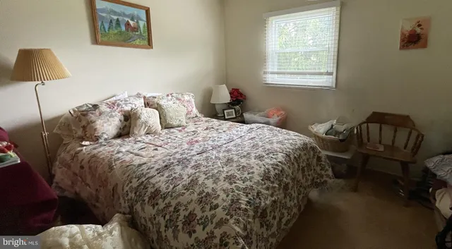 a bed sitting in a bedroom next to a window