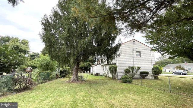 a view of a backyard with table and chairs and a fire pit