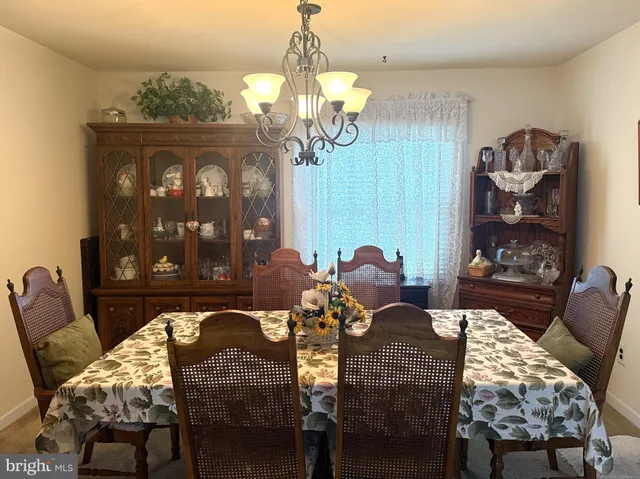 a view of a dining room with furniture and chandelier