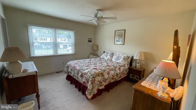 a bedroom with bed chair and window