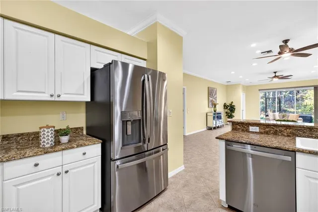 a kitchen with stainless steel appliances granite countertop a refrigerator and a stove