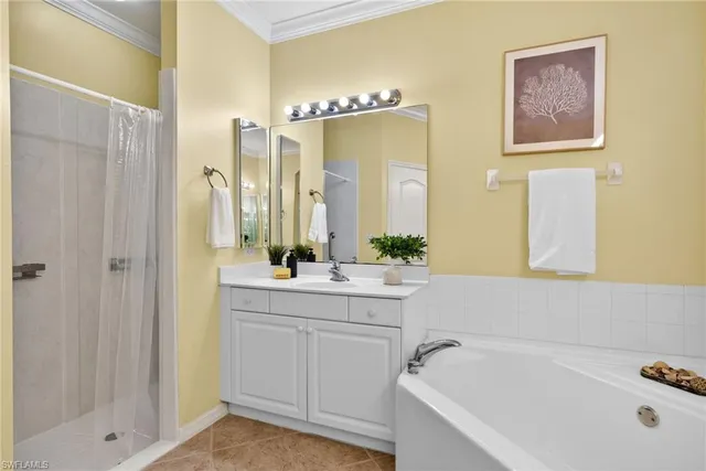 a bathroom with a tub a sink and mirror