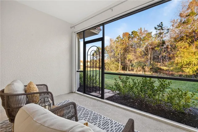 a view of a porch with furniture and garden