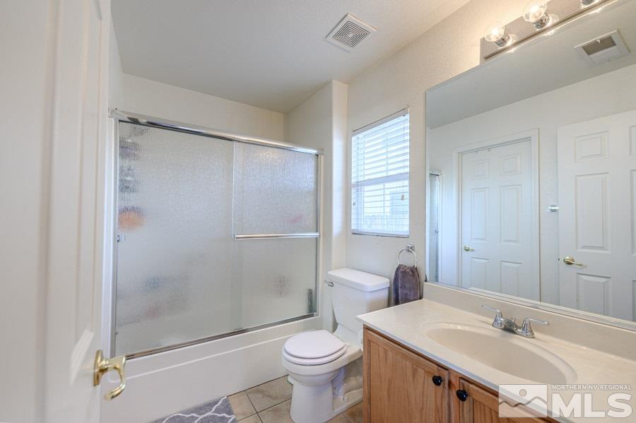 7635 Corso Street Reno, NV 89506 - Photo 12 of 19 a bathroom with a sink toilet and shower
