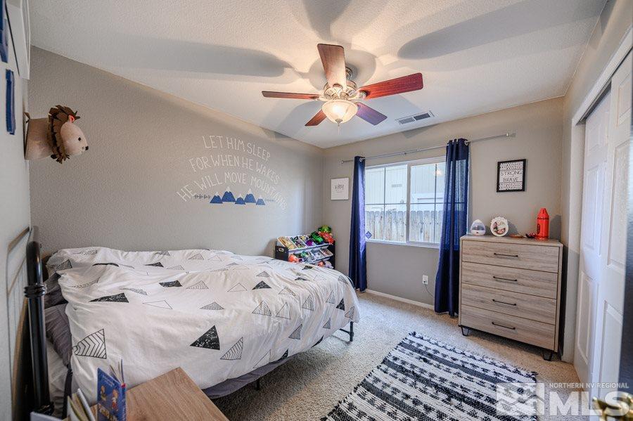 7635 Corso Street Reno, NV 89506 - Photo 14 of 19 a bedroom with a bed and a chandelier