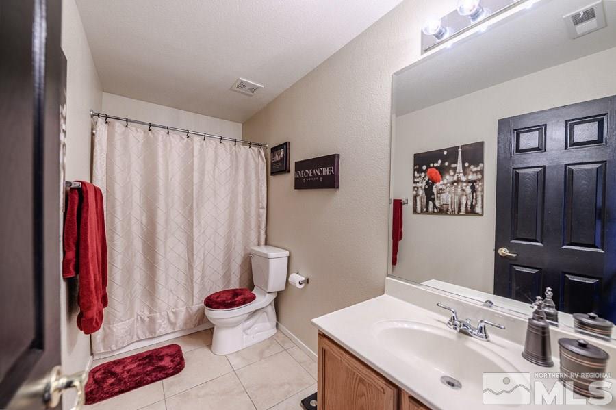 7635 Corso Street Reno, NV 89506 - Photo 15 of 19 a bathroom with a sink and a mirror